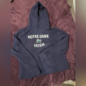 UA gently worn blue Norte dame hoodie with a raw hemline
